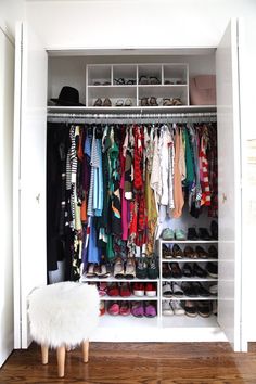 an organized closet with clothes and shoes