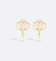 The Petit CD earrings are a work of elegance and refinement, available this season as clip-ons. The style is distinguished by a white resin pearl hanging from a gold-finish metal CD signature. The earrings can be styled with other Petit CD creations for a modern and sophisticated look.. Designer Gold-tone Clip-on Earrings, Designer Gold Drop Pearl Earrings, Designer Gold Pearl Drop Earrings, Luxury White Drop Clip-on Earrings, Luxury White Clip-on Drop Earrings, Cd Earrings, Resin Pearl, Dior Jewelry, Gold Finish