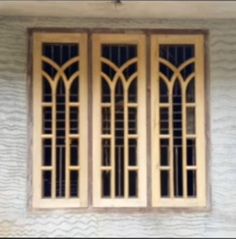 the window is made of wood and has three panes with arched windows on each side