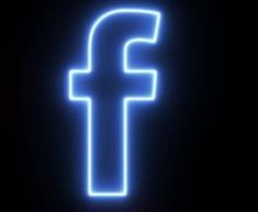 the facebook logo is glowing blue in the dark