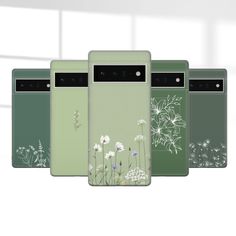 four cell phones with flowers on them are lined up in a row against a white background