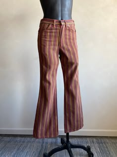 "Beautiful 70s Striped Denim Jeans by Wrangler. Striped multicolor pattern design made from cotton fibers in the USA. Pants have a zipper fly closure. Denim is super soft! Condition overall is great with no noted flaws. No rips, tears, or stains. Please see all photos for details.  Refer to measurements below to ensure a proper fit (modeled on a size small mannequin) 14\" across waist 16\" across hip 11\" rise 30\" inseam" 70s Style Jeans, 70s Fashion Colorful, High Rise Multicolor Cotton Pants, Multicolor High Rise Cotton Pants, 70s Inspired Cotton Bottoms For Fall, 70s Inspired Cotton Pants For Fall, Retro Multicolor Spring Jeans, Multicolor Retro Spring Jeans, Multicolor Full Length Jeans For Fall