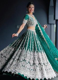 a woman in a green and white lehenga