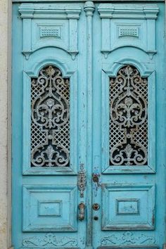 an old blue door with ornate carvings on it