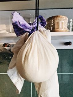 a white bag hanging from a hook in a kitchen