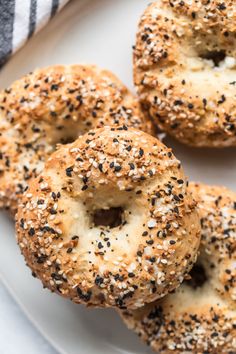 sesame seed bagels on a white plate