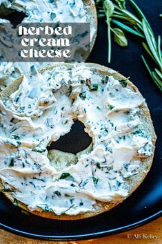 a bagel with cream cheese and herbs on it