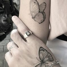 two people with tattoos on their arms and one has a butterfly tattoo on the arm