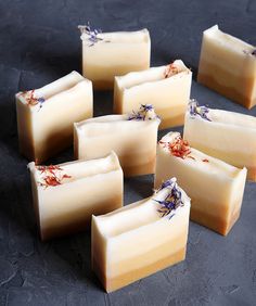 nine bars of soap with flowers on them sitting on a table top next to each other