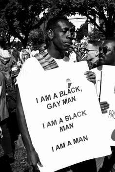 black men holding protest signs in the street