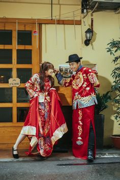 a man and woman dressed in traditional chinese costumes