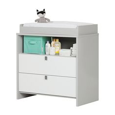 a baby changing table with two drawers and a stuffed animal