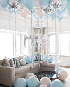 balloons and streamers fill the air in this living room decorated for a new year's eve celebration