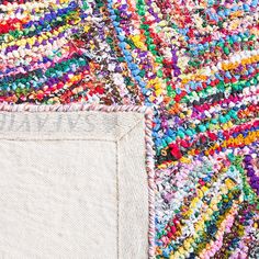 a pile of colorful rugs sitting next to each other on top of a floor