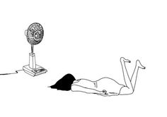 a person laying on the ground with a fan in front of them, and an electric device connected to it