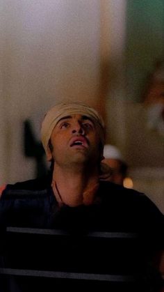 a man with a turban looking up at something