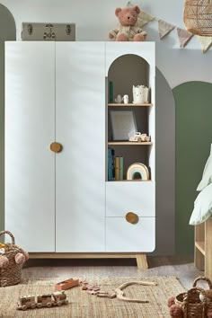 a child's bedroom with an armoire and toys on the floor in front of it