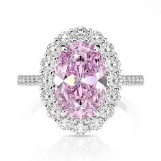 a pink and white diamond ring with diamonds around it's center stone, set in 18k white gold