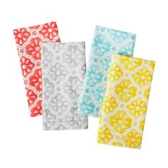 four different colored napkins with designs on them