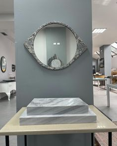 a large mirror on the wall above a table