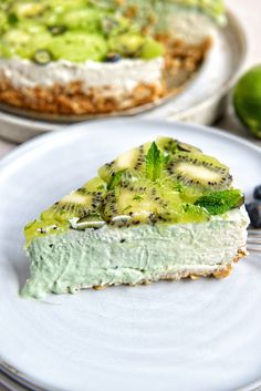 there is a piece of pie on the plate with blueberries and kiwis