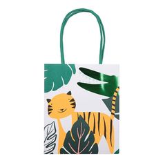 a paper bag with a tiger design on the front and green handles, hanging from a string