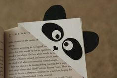 an open book with a panda face cut out of it