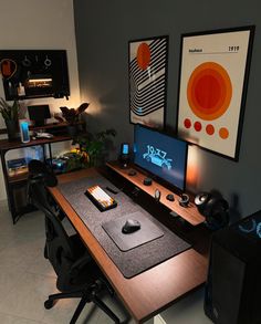 a computer desk topped with a monitor and keyboard next to a mouse pad on top of a wooden table