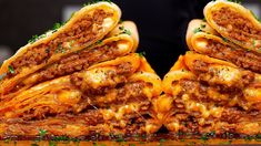 some very tasty looking sandwiches stacked on top of each other