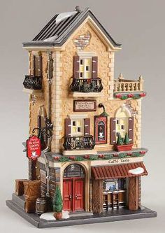 a toy house with lots of windows and shutters