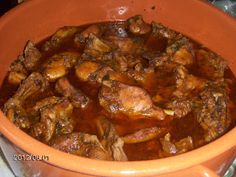 a pot filled with meat and sauce on top of a stove