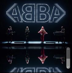 a group of people standing on top of a stage with the words abriba above them