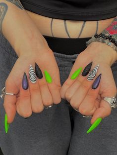 Modern Goth Nails, Halloween Nails Holographic, Icp Juggalo Nail Ideas, Beetlejuice Nails Stiletto, Simple Spooky Nails Almond, Purple Green And Orange Nails, Goth Pride Nail, Green And Purple Acrylic Nails, Beetlejuice Halloween Nails