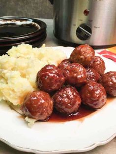 meatballs and mashed potatoes on a plate with an electric pressure cooker in the background