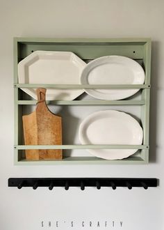 there is a shelf with plates and knives on it