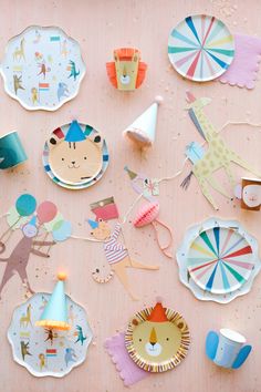 paper plates and party hats are laid out on a table