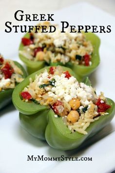 three stuffed peppers on a white plate topped with cheese and other toppings that include spinach