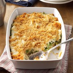 a casserole dish with broccoli and cheese in it on a table