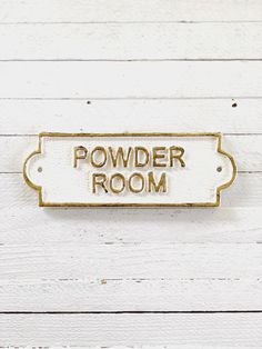 a sign that says powder room on the side of a white wooden wall with wood planks