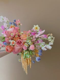 a woman holding a bouquet of flowers in her hand