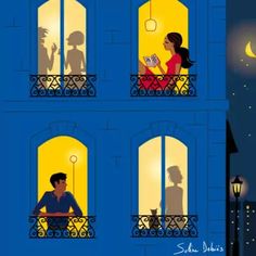 a man and woman are sitting on the balcony looking out at the night sky with their cats