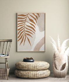 a living room with two wicker chairs and a painting on the wall