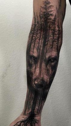 a man's arm with trees and roots on it