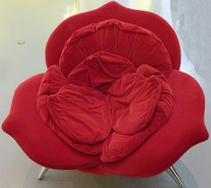 a red chair sitting on top of a white table