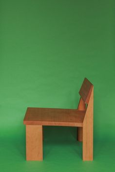 a small wooden bench against a green background