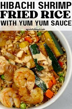 shrimp fried rice with zucchini and vegetables in a white bowl