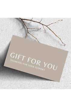 a gift card with the words thank you for your support on it next to a twig