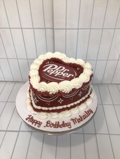 a heart shaped birthday cake with the words happy birthday written on it