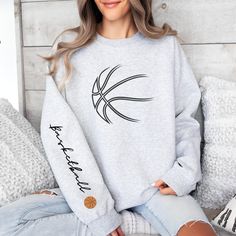 Get ready for some basketball action and show your love for the game with this cutie! Not found in stores so be UNIQUE and grab this cute and cozy sweatshirt today!  Gildan Brand Unisex Sweatshirt .: Made with a medium-heavy fabric blend of 50% cotton and 50% polyester (8.0 oz/yd² (271.25 g/m²) .: The classic fit along with the crew neckline deliver a comfy wearing experience with a clean-cut style.  .: Say goodbye to itchiness thanks to the gray, pearlized tear-away label.  .: Made using 100% e Cricut Crew Neck Sweatshirt Basketball, Basketball Sweatshirts Design, Basketball T-shirt With Letter Print And Crew Neck, Basketball Fan Apparel T-shirt With Crew Neck, Team Spirit Shirts, Basketball Sweatshirts