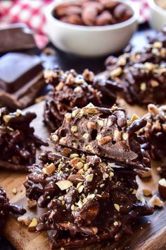 chocolate covered cookies with nuts on a cutting board